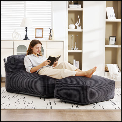 Grand pouf en velours côtelé et mousse à mémoire de forme avec repose-pieds pour une détente et un confort ergonomiques pour adultes.