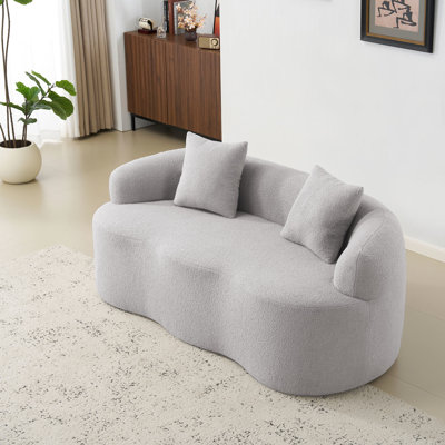 Canapé d'angle gris incurvé avec accoudoirs ronds, 2 places, compression, pour toutes les pièces, sans montage, entretien facile, soutien ergonomique, confort optimal, idéal pour le salon ou le bureau.