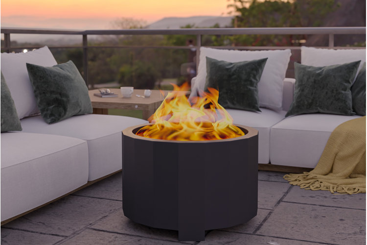 black smokeless fire pit in the middle of two white patio sofas