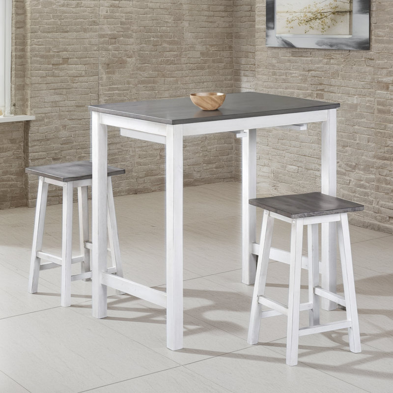 Ensemble de table de salle à manger 3 pièces à hauteur de comptoir. Table compacte et peu encombrante avec 2 tabourets. Finition en bois gris. Facile à nettoyer.