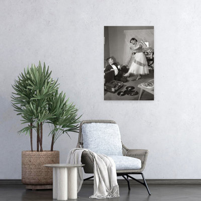 1950S 1960S Teen Couple In Living Room In Prom Dress & Tuxedo Guy Sitting On Floor & Girl Dancing To Music From A Record Player Romantic Contempora...