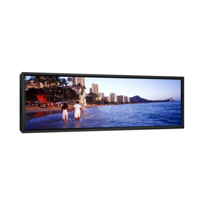 " Rear View Of A Couple Wading On The Beach, Waikiki Beach, Honolulu, Oahu, Hawaii, USA " by Panoramic Images