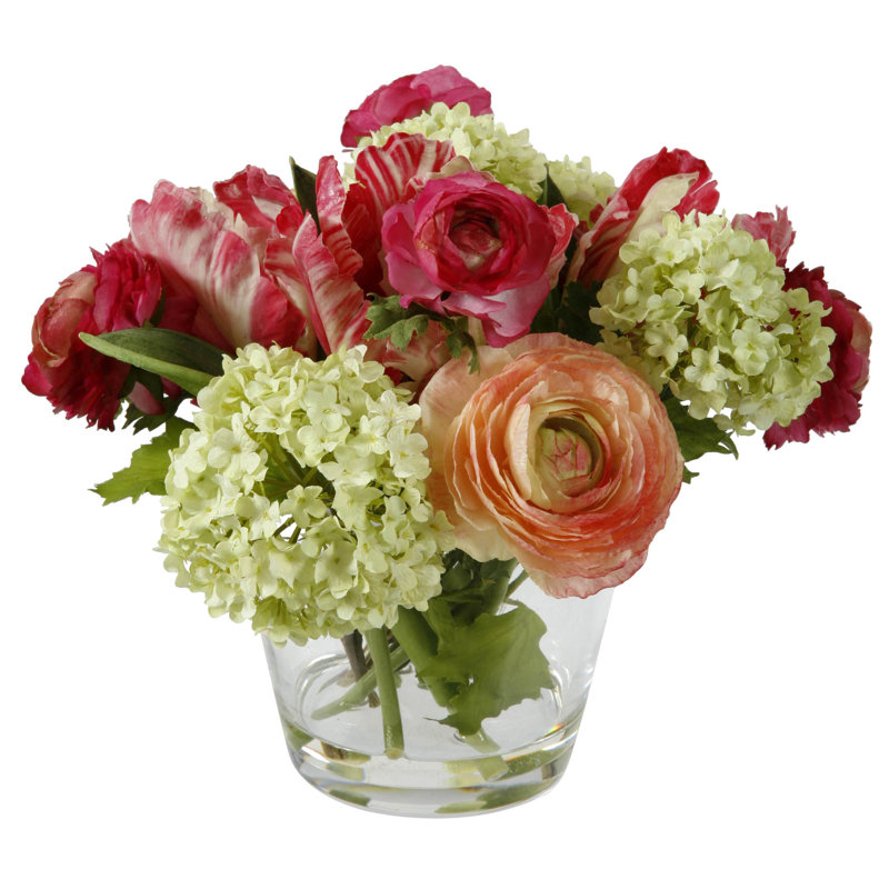 Arrangement floral à ressorts mélangés dans un vase en verre