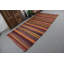 Tapis turc traditionnel fabriqué à la main dans un mélange vibrant de tons vifs d'orange