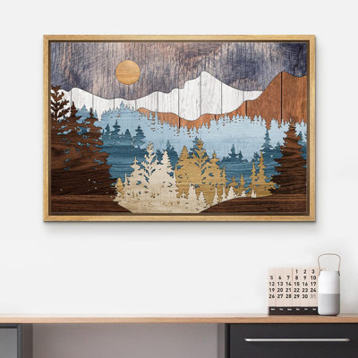 Framed landscape wall art featuring a multi-layered wood-effect mountain and forest scene in shades of blue and brown.