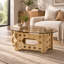 Table basse ovale de 98 x 58 cm avec dessus en verre caramel et piètement en bois sculpté