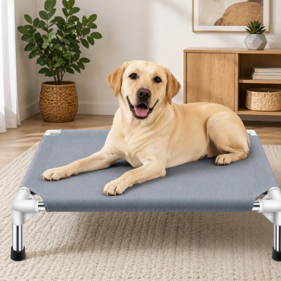 Portable raised cooling dog bed/cot for medium dogs, measuring 34"L x 26"W x 6.5"H, with double-layer polyester cotton and no-slip rubber feet for outdoor use.
