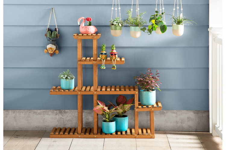 wooden multi-level planter stand with various planters