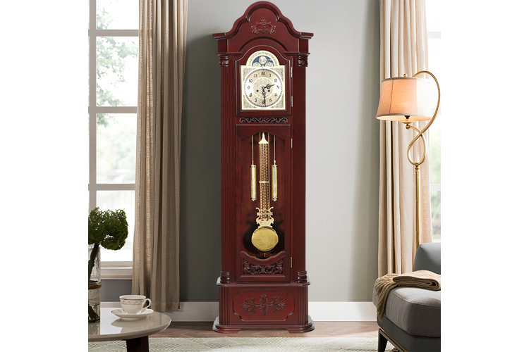 a cherry wood grandfather clock with an arched crown