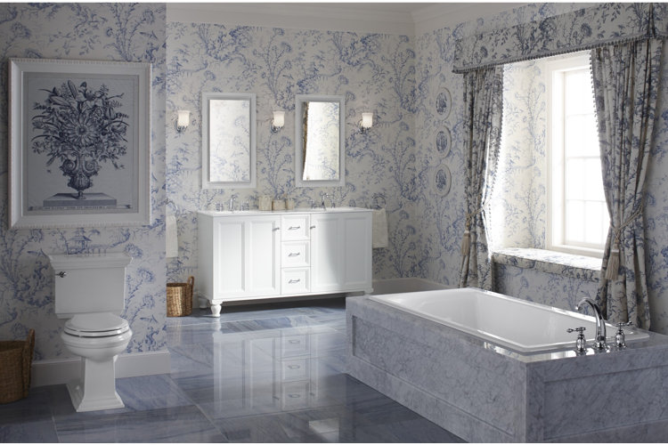 bathtub with marble tile surrounding it