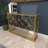 Beritan Metal Weathered Geometric Gold Console Table with Mirrored Glass Top