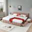 Très grand lit avec revêtement en chenille rose et tiroirs pour un environnement de chambre à coucher moderne et confortable.-169613885