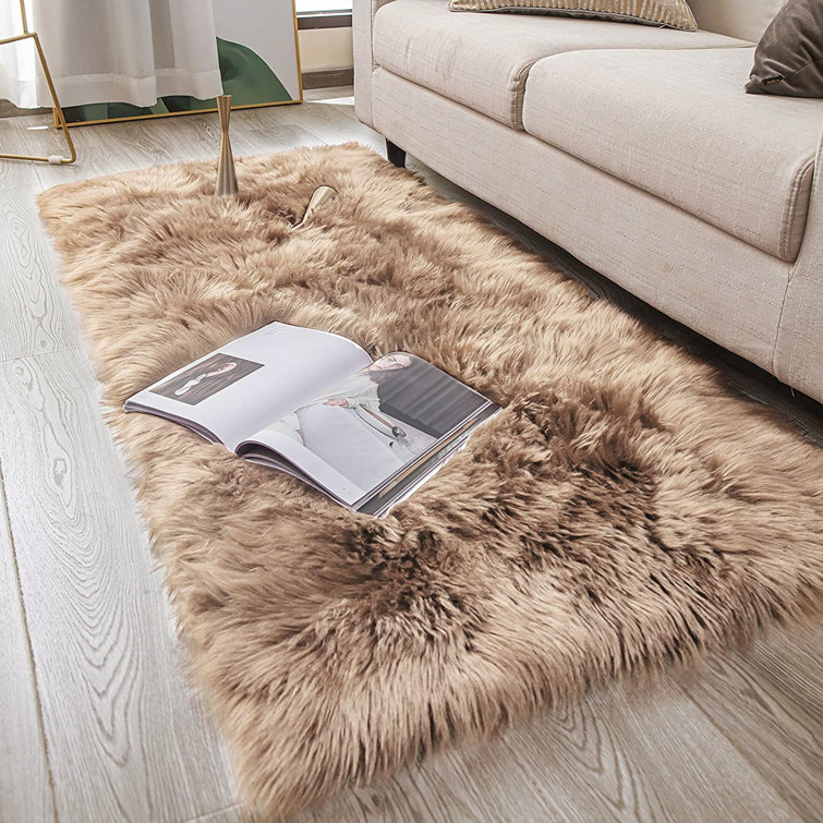 https://assets.wfcdn.com/im/52077048/resize-h755-w755%5Ecompr-r85/2479/247937029/Malaiah+Handmade+Faux+Sheepskin+Beige+Rug.jpg