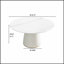 Table de salle à manger ronde moderne en pierre artificielle noire avec base en polyuréthane beige, pouvant accueillir 6 personnes pour des repas et des rassemblements élégants.-488618645-488618643