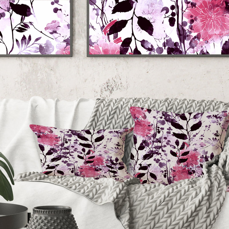 Coussin décoratif imprimé à motif de feuilles roses et noires sur fond blanc