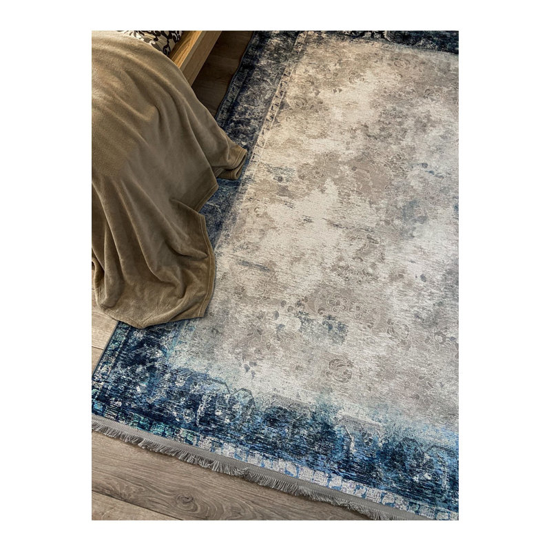 Tapis bleu lavable à motif frangé classique