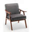 Fauteuil d'appoint en velours gris avec structure en bois, pour une ambiance accueillante. Construction robuste, s'intègre parfaitement dans une entrée.