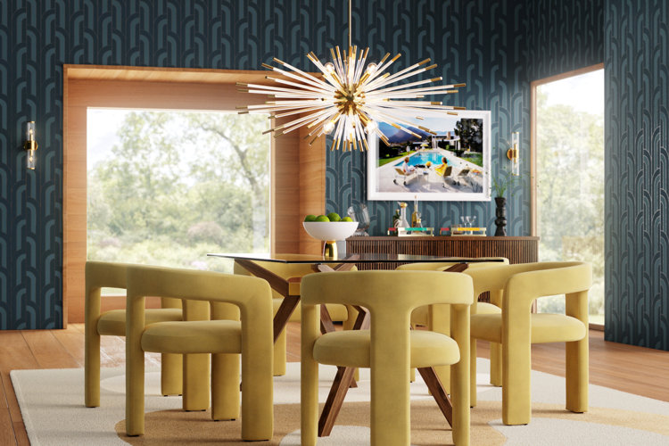 Modern art deco dining room with blue geometric wallpaper and a sputnik chandelier over a glass table with yellow chairs.