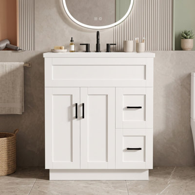 Meuble-lavabo avec lavabo en résine, 2 tiroirs à fermeture amortie, tablette réglable et dos ouvert pour faciliter l'accès à la plomberie.