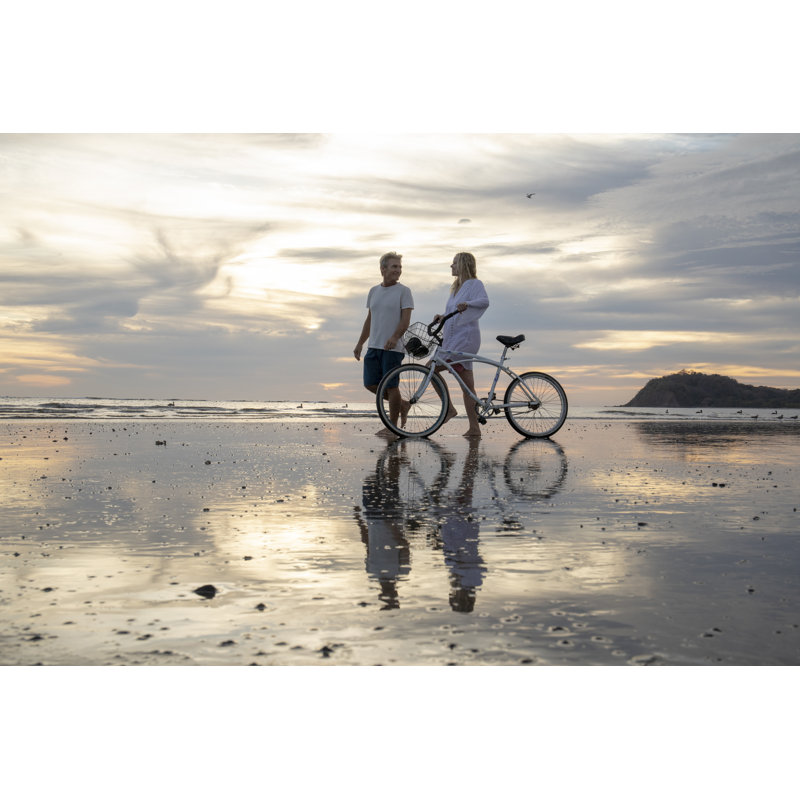 Mature Couple Push Bike Down Beach At Sunrise by AscentXmedia - No Frame Print on Canvas, 30cm H x 46cm W