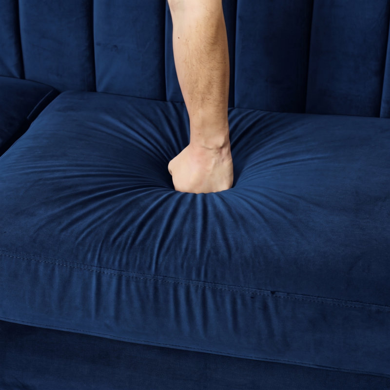 Canapé bleu marine capitonné, accoudoirs arrondis et finitions cloutées., Sofa