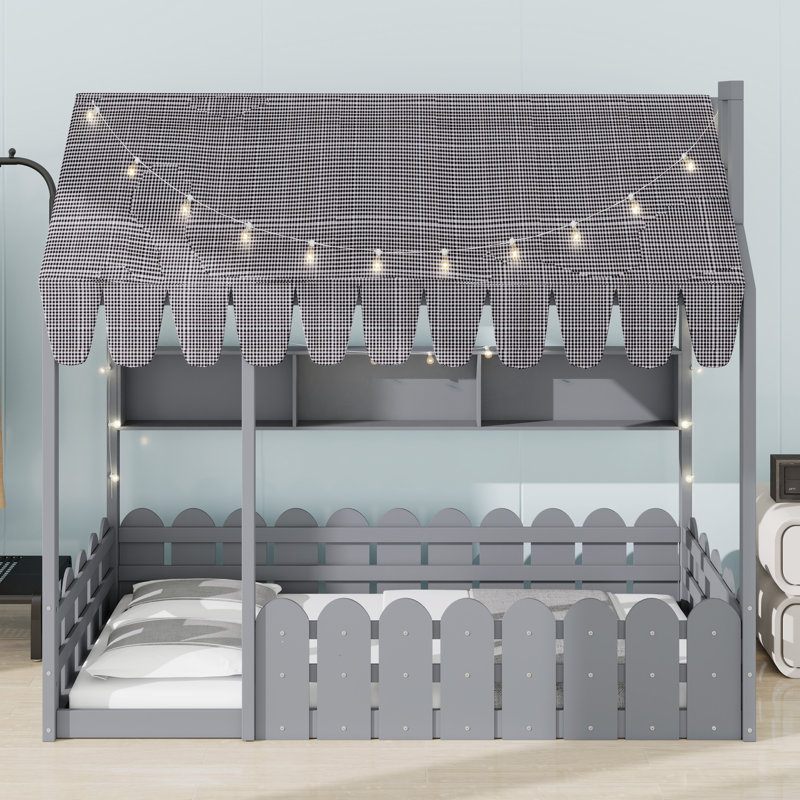 Lit de plancher pour enfant équipé d'une clôture de sécurité, d'une tente de jeu, de lumières décoratives et de compartiments de rangement