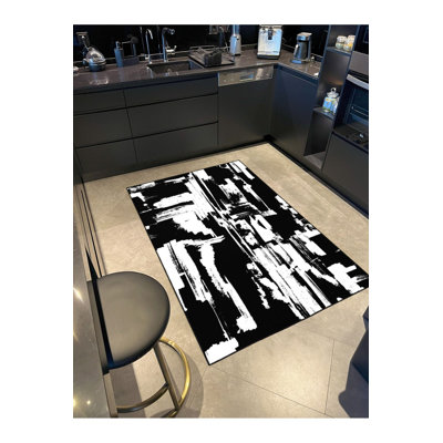 Tapis noir lavable à motif tressé illustré