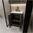 A 24-Inch Black Bathroom Cabinet, Paired With A White Ceramic Basin, Has A Modern Design And Is Made Of Materials That Are Waterproof And Durable.