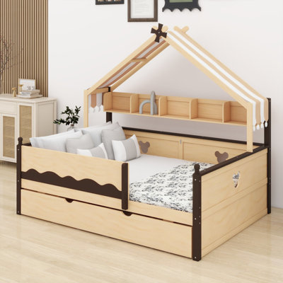 Le lit de jour avec lit gigogne et tablette est doté d'une structure à baldaquin en forme de maison pour les chambres d'enfants.