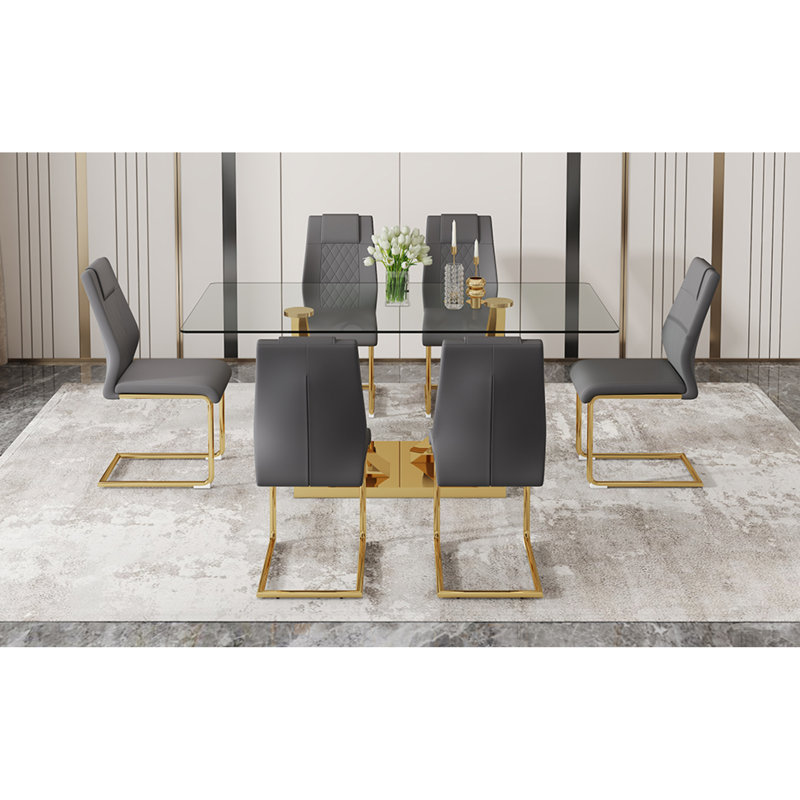 Table de salle à manger moderne avec plateau en verre trempé transparent et pieds en métal plaqué or