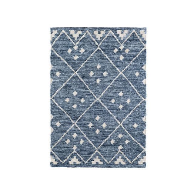 Blue area rug with a white diamond lattice pattern and small geometric accents within each diamond.