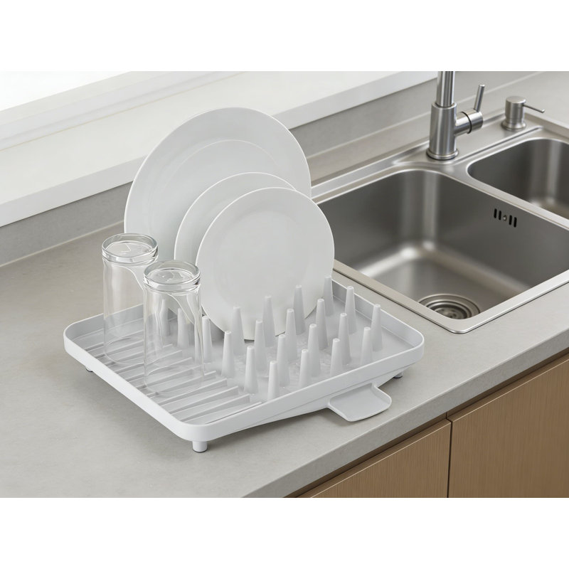 Égouttoir à vaisselle compact avec porte-ustensiles, conception de séchage efficace avec base inclinée et bec de drain pour une organisation de cuisine peu encombrante