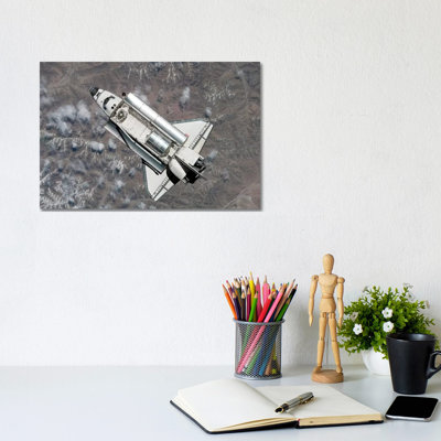 Aerial View Of Space Shuttle Discovery Over Earth As It Approaches The International Space Station by Stocktrek Images - Wrapped Canvas Print