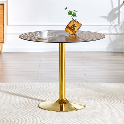 Table ronde en verre brun clair de 35 pouces de diamètre. Pilier en métal doré. Négociation, table basse de maison, table de salle à manger. Convient aux petits espaces repas de 2 à 4 personnes.