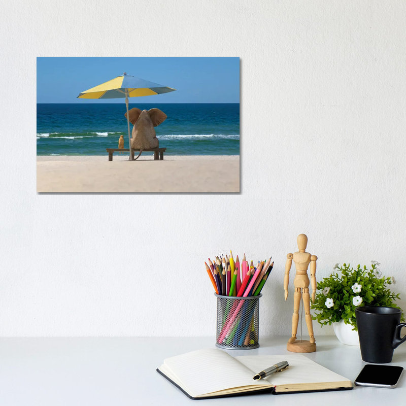 Elephant And Dog Sit Under An Umbrella On The Sea Beach by Mike Kiev - Wrapped Canvas Print, 20.32 cm H x 30.48 cm W