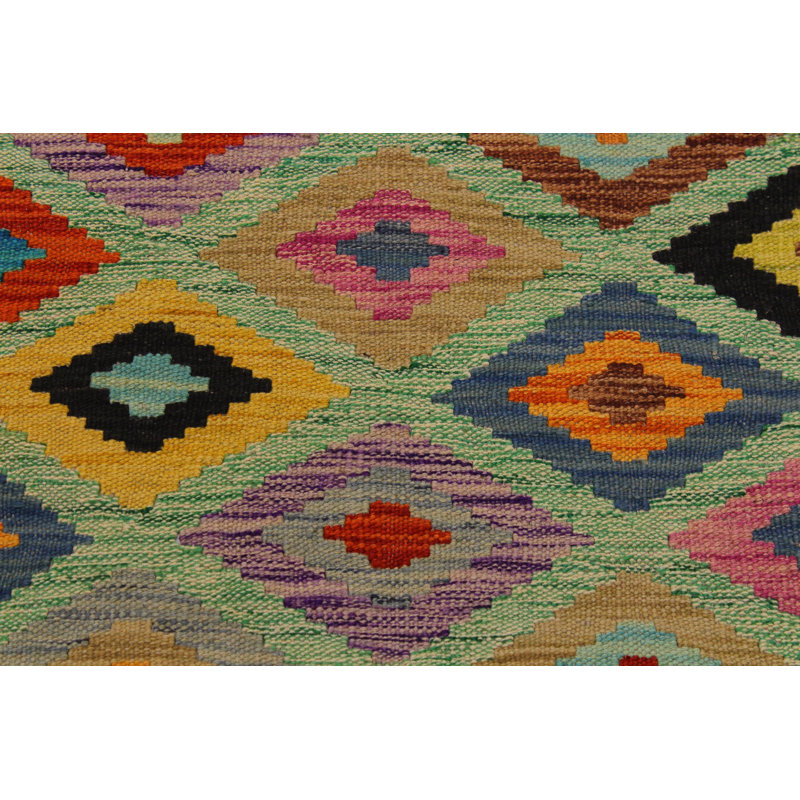 Madee Geometric Handmade Rectangle 6'8" x 9'9" Wool Area Rug in Green/Brown/Red