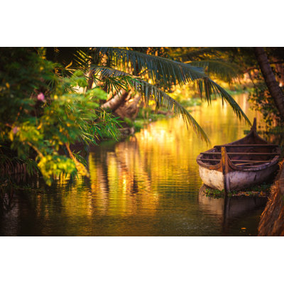 Boat In A Small Canal Of Kerala by Thepalmer - Wrapped Canvas Print