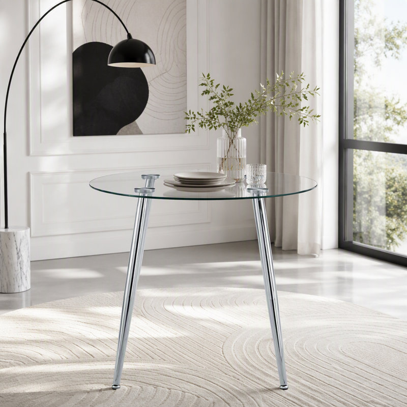 Table de salle à manger ronde avec dessus en verre et pieds argentés
