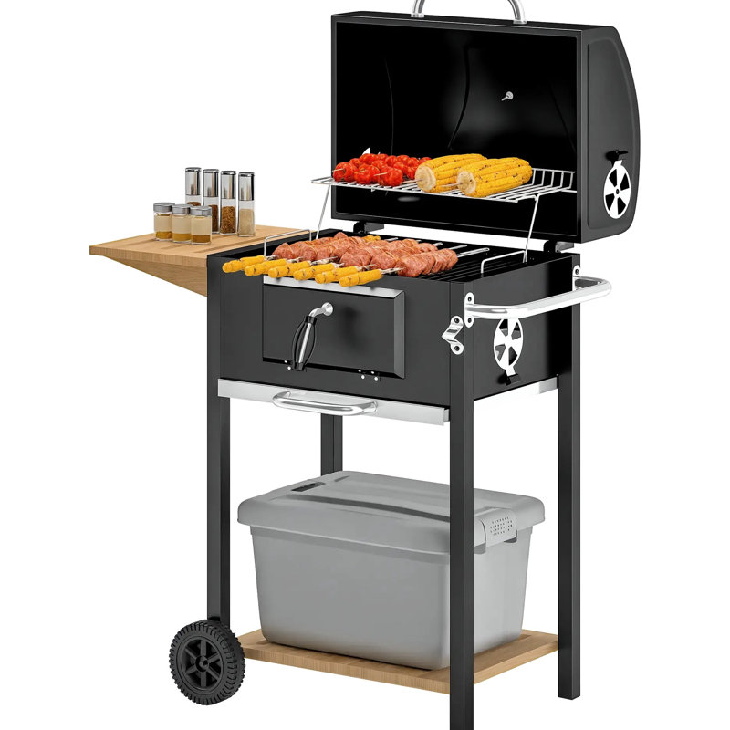 Barbecue portatif extérieur au charbon de bois noir avec plaque de cuisson réglable, deux roulettes pour la mobilité et une poignée de transport latérale