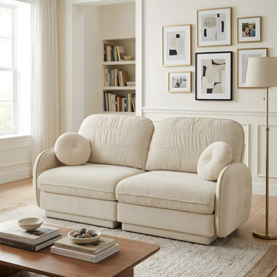 A deep-seated sofa in the living room, complete with round cushions
