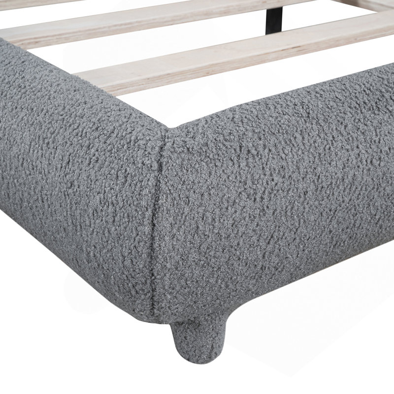 Lit plateforme tapissier avec tissu épais, structure solide et design élégant en forme de courbe