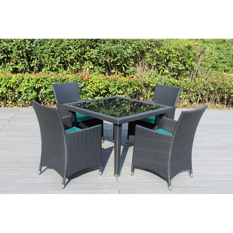 Lumini 4 - Person Wicker Patio Dining Set with Square Table , Cushions Included, Canvas Aruba Sunbrella® Canvas