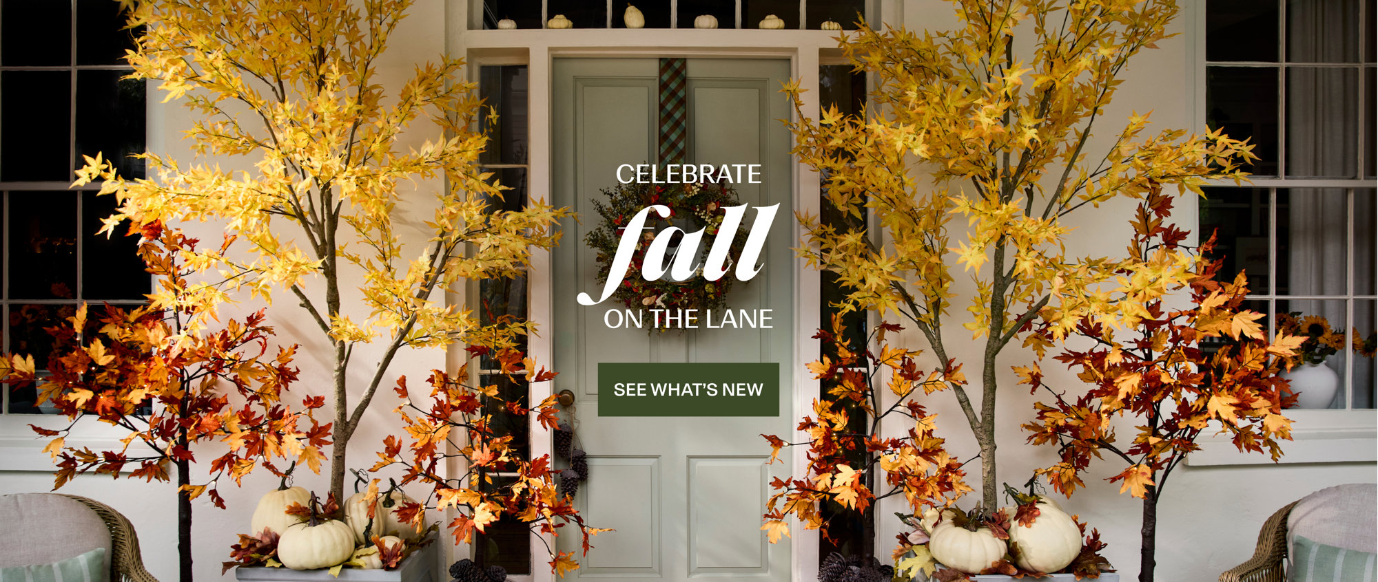 Celebrate fall on the lane with a festively decorated front porch featuring white pumpkins, fall wreaths, and autumn trees. See what's new.