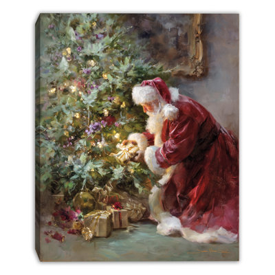 Art mural sur toile tendue Père Noël plaçant des cadeaux par l'arbre de Noël