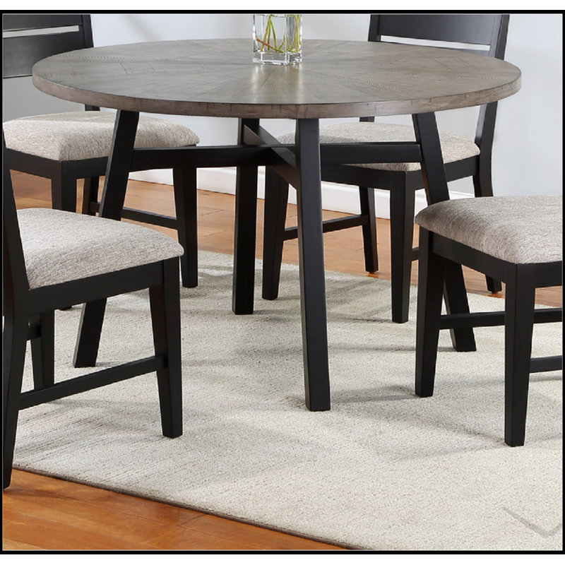 Table de salle à manger ronde contemporaine gris clair avec base noire robuste, parfaite pour les maisons modernes et peu encombrantes