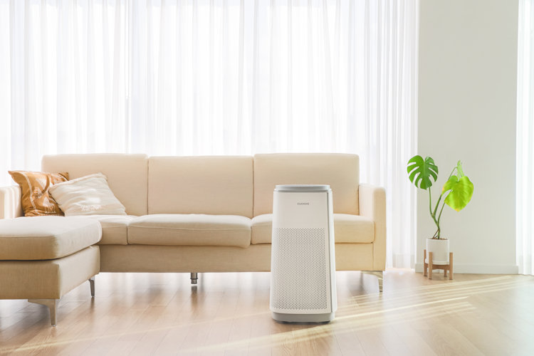 freestanding air purifier in front of a beige sofa