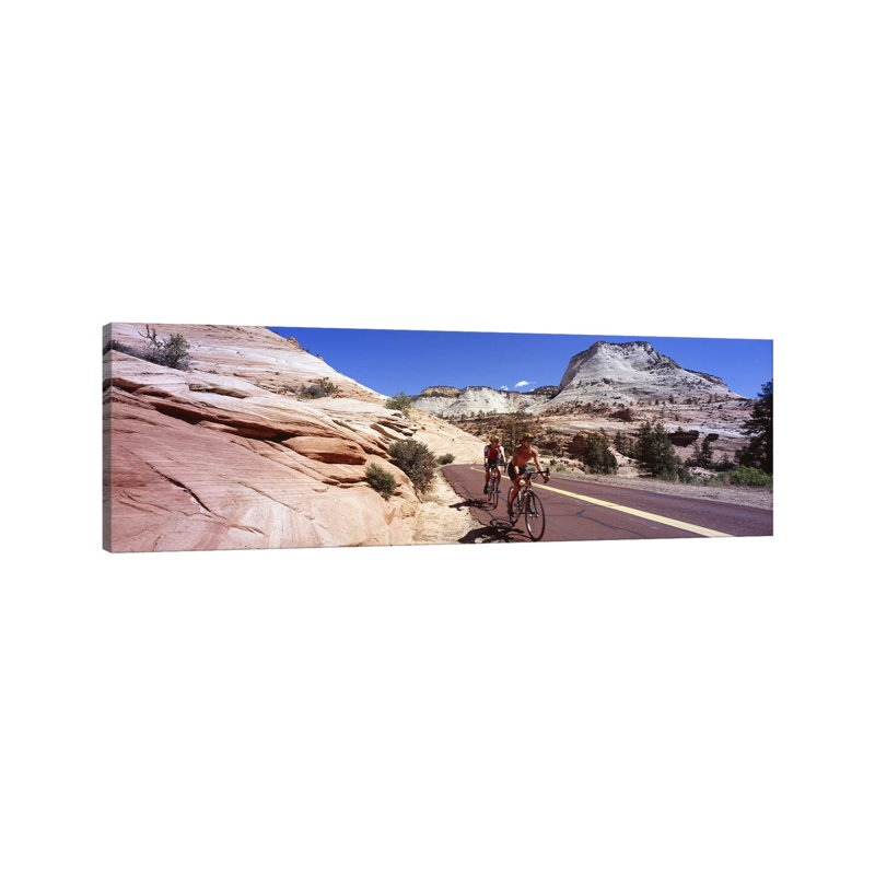 Two People Cycling On The Road, Zion National Park, Utah, USA by Panoramic Images - Wrapped Canvas Panoramic Print