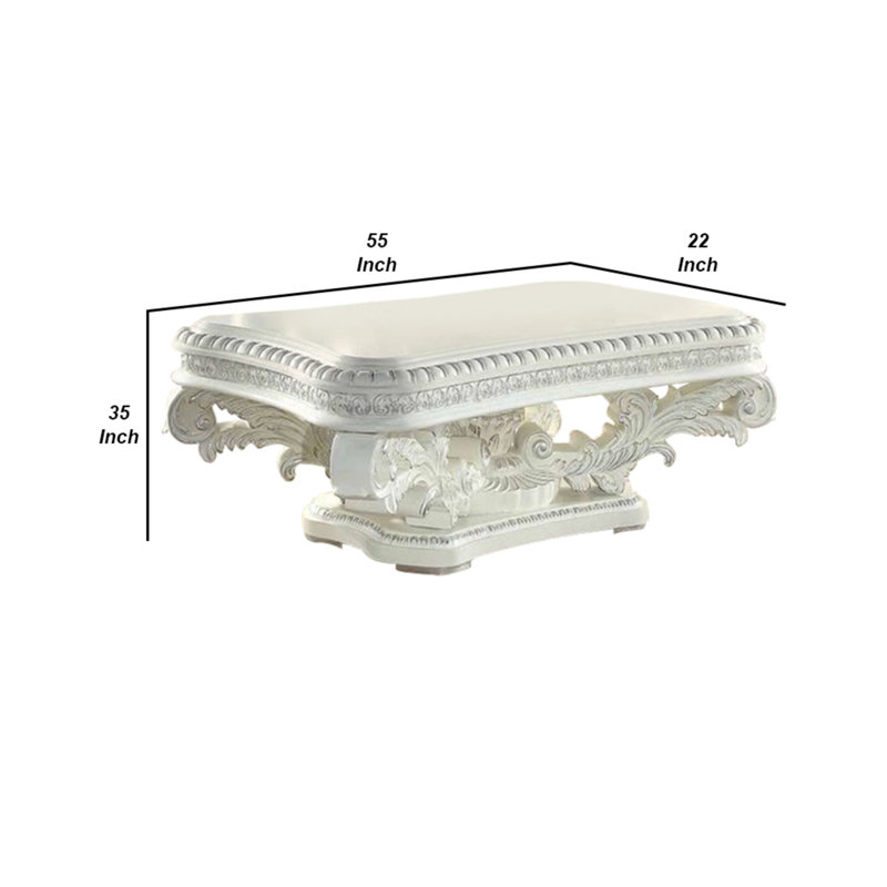 Kin 55" White Ornate Wood Coffee Table with Scrolled Pedestal