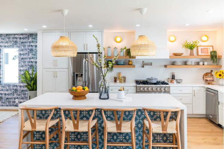 Earthy boho kitchen with rattan fruit bowl on counter wood top glass food canisters and wooden cutting board