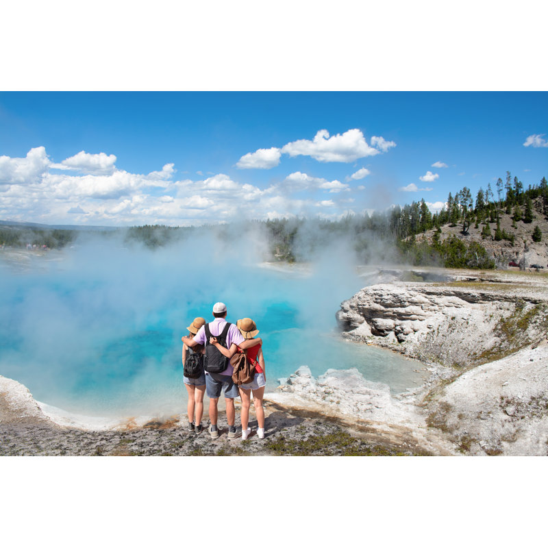Family Relaxing And Enjoying Beautiful View On Vacation Hiking Trip by MargaretW - Wrapped Canvas Print